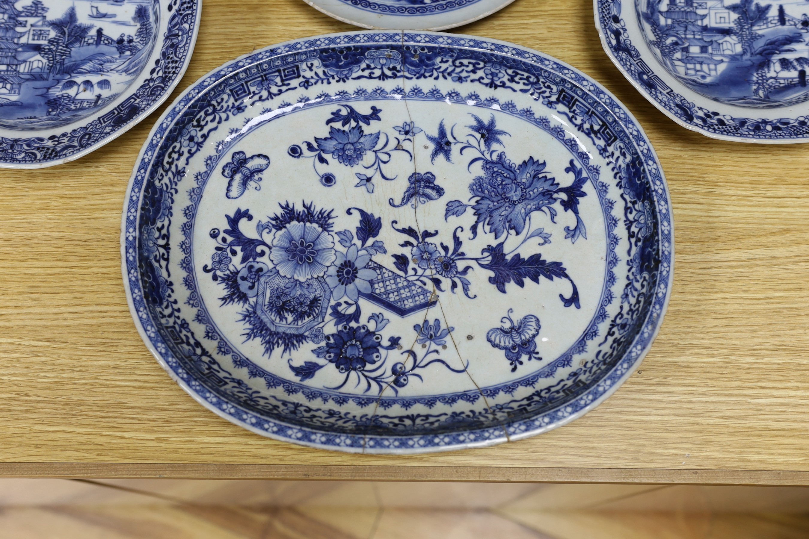 A selection of severn 18th century Chinese export blue and white dishes, largest 35cm wide